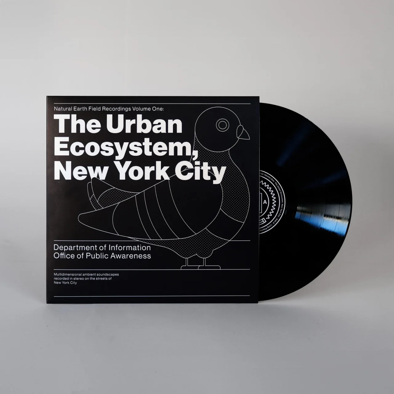 Photograph of the black record jacket for The Urban Ecosystem, New York City, with the record half out of the sleeve on the right. The label shows the seal's radio-wave ring.